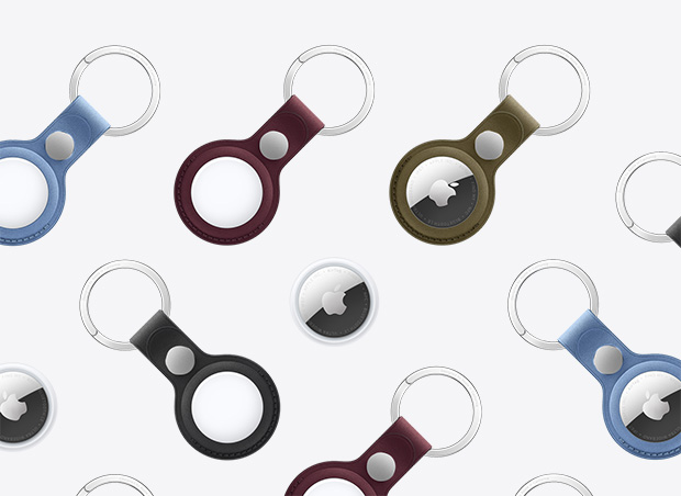 AirTag e chaveiro de tecido FineWoven para AirTag em várias cores, incluindo glacial, bordô e verde. Os acessórios têm o logotipo da Apple na parte da frente.