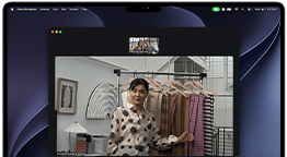 A video call on a MacBook Pro where a woman shows fabrics to two people on the call, with Center Stage keeping her centered in the frame as she moves around