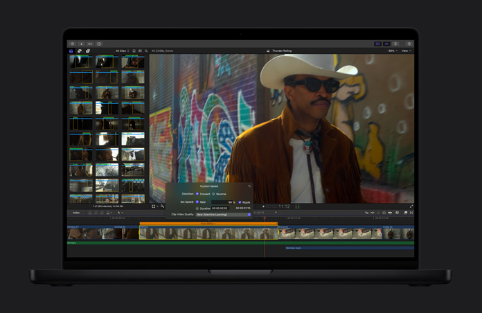16 Zoll MacBook Pro, Demonstration, wie eine Aufnahme in flüssige Zeitlupe umgewandelt werden kann, ein Mann mit Cowboyhut und Sonnenbrille steht vor einer mit Graffiti bemalten Wand