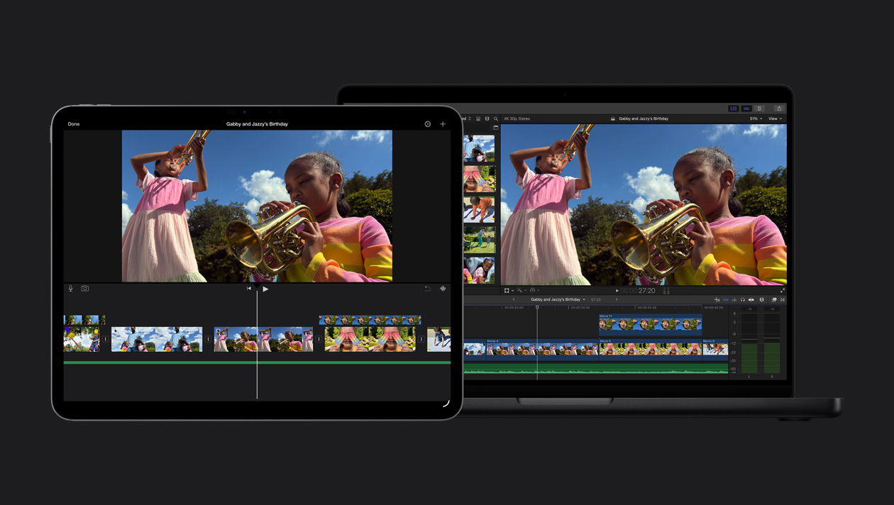 Ein 14 Zoll MacBook Pro Bildschirm zeigt zwei Mädchen, die im Freien Trompete spielen, eine Demo des iMovie Imports, Clips, ein 13 Zoll iPad Pro Display zeigt zwei Mädchen, die im Freien Trompete spielen, eine Demo des iMovie Imports, Clips unten